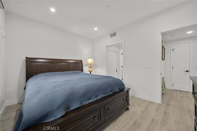 a bedroom with a bed and a dresser