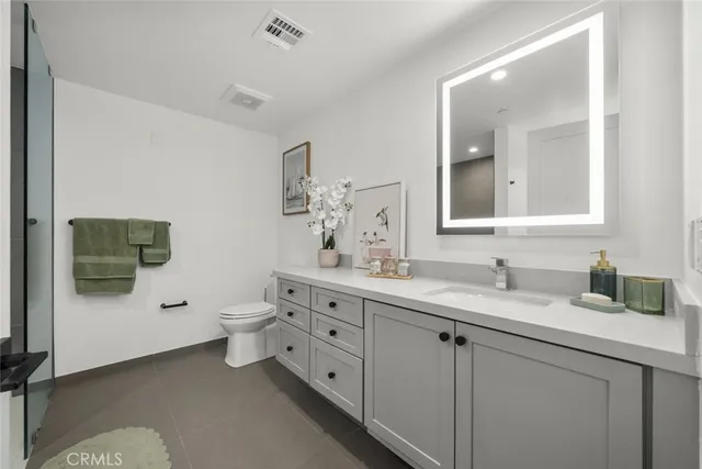 a bathroom with a tub a toilet and a shower