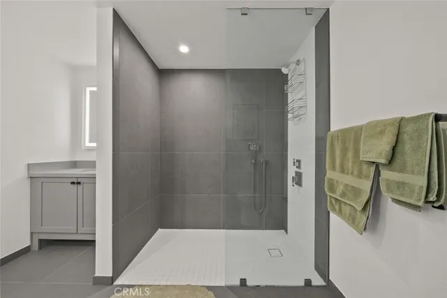 a bathroom with a sink a mirror and a shower