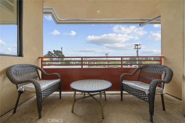 a view of a hallway with furniture and a window