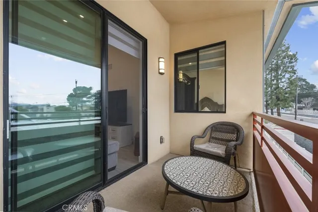 a view of a chair and tables in the balcony