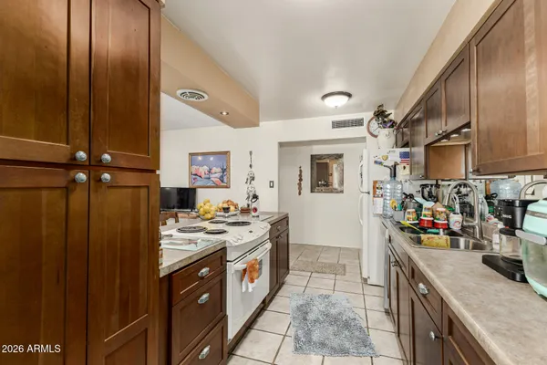a kitchen with stainless steel appliances granite countertop a sink stove and cabinets