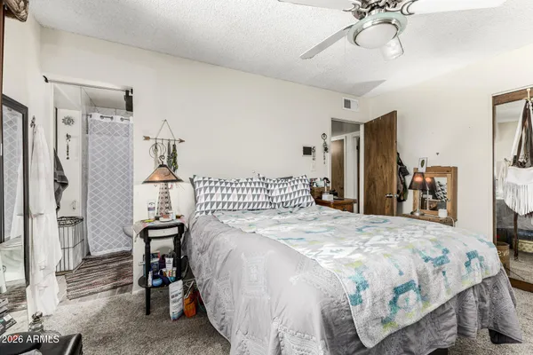 a bedroom with a bed and a chandelier