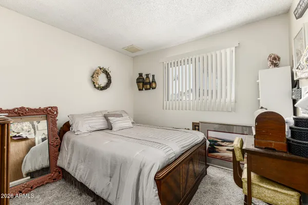 a bedroom with a bed and a chair