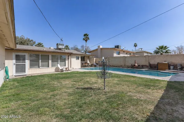a view of a house with a backyard