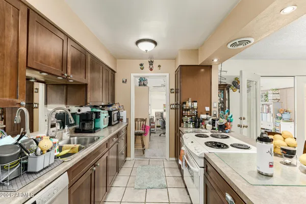 a kitchen with stove a sink and cabinets