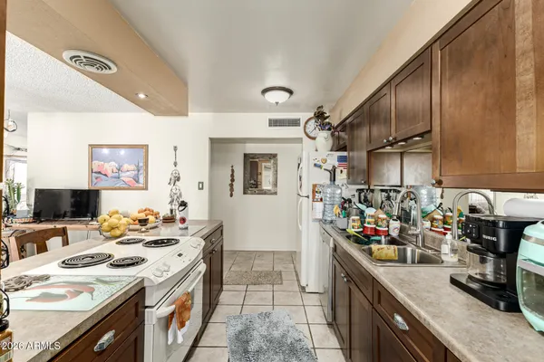 a kitchen that has a lot of cabinets a sink and a stove