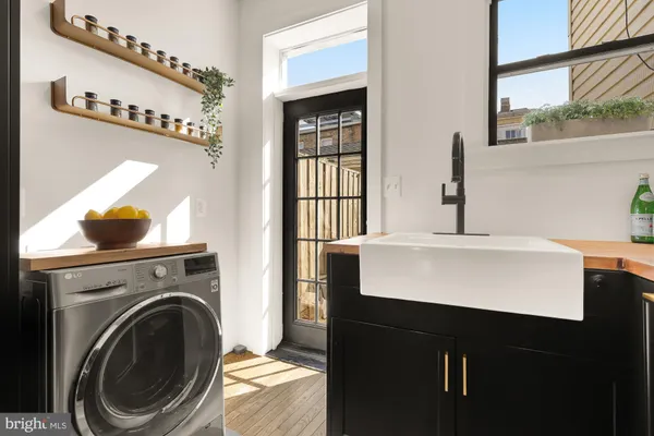 a room with a sink a washer and dryer