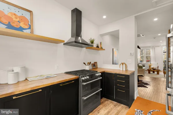 a kitchen with stainless steel appliances granite countertop a sink stove and cabinets