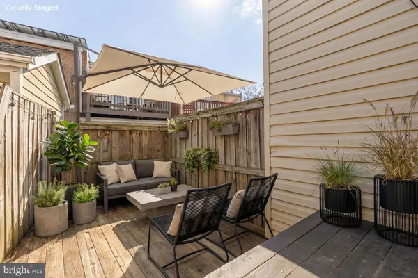 a view of a patio with couple of couches and potted plants
