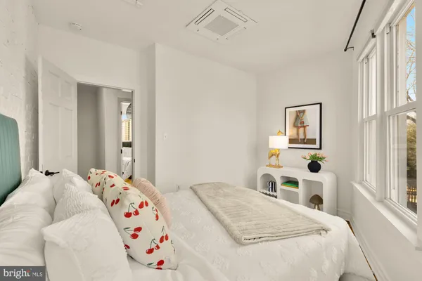 a bedroom with a bed and a window