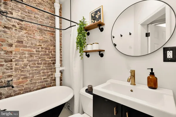 a bathroom with a sink a mirror and a toilet