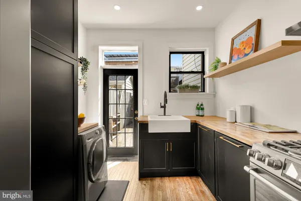 a kitchen with a sink appliances and cabinets