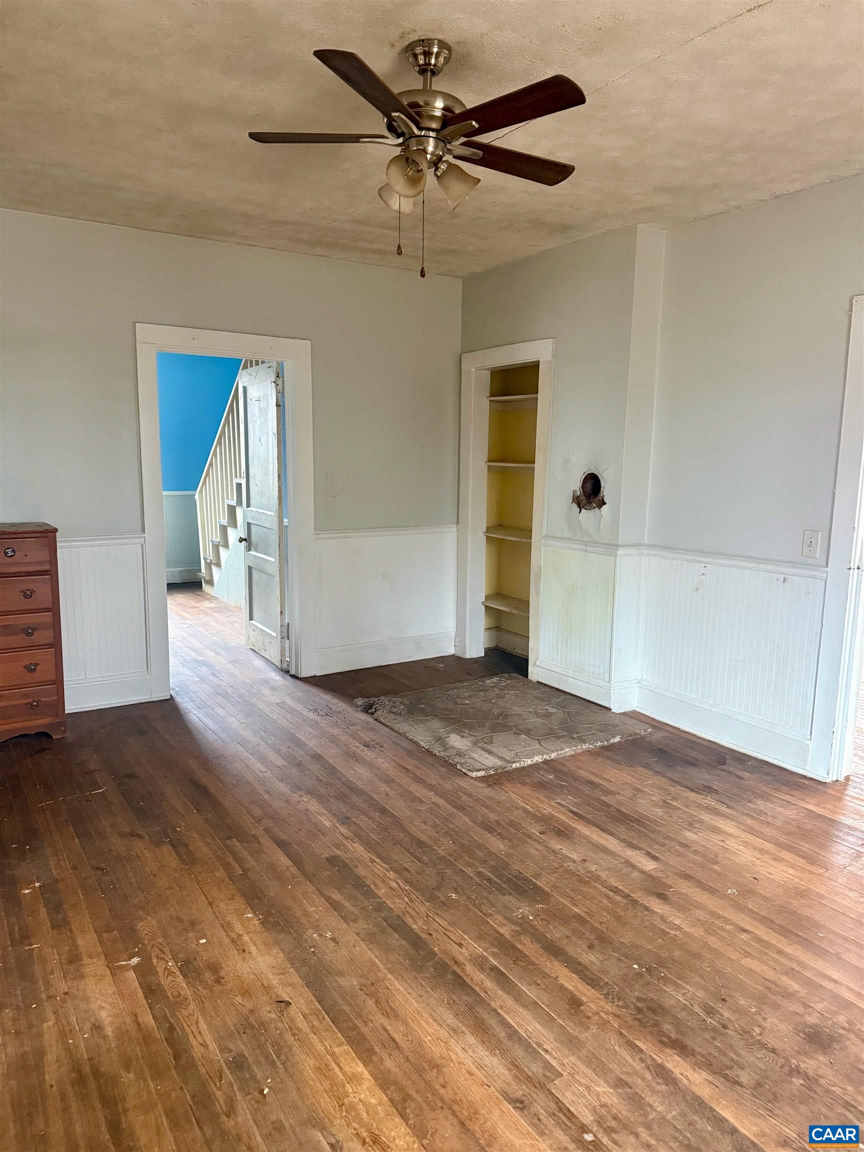 3127 Courthouse Road Palmyra, VA 22963 - Photo 4 of 16 an empty room with wooden floor chandelier fan and windows