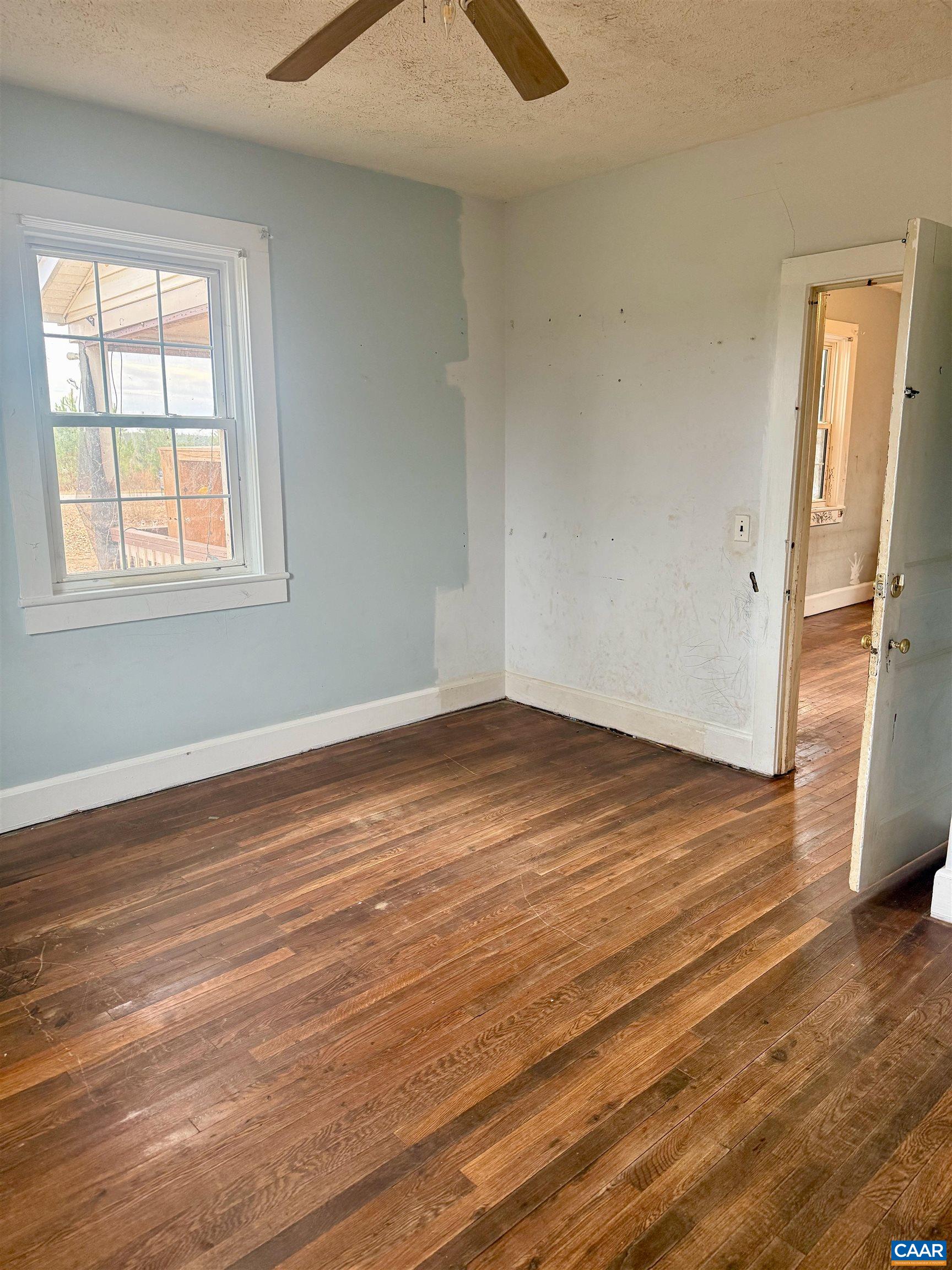 3127 Courthouse Road Palmyra, VA 22963 - Photo 7 of 16 an empty room with wooden floor and a window