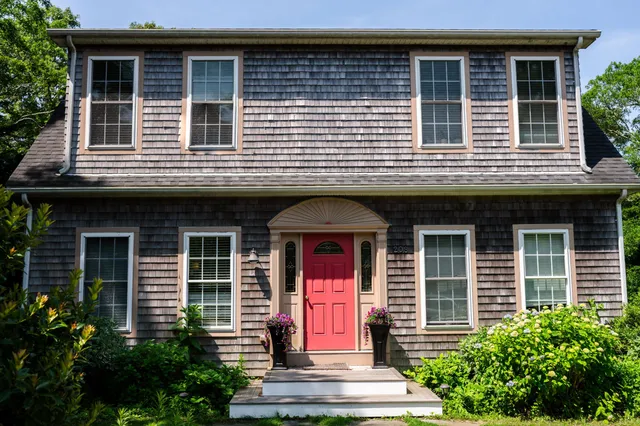 a balcony with a book and wooden fence