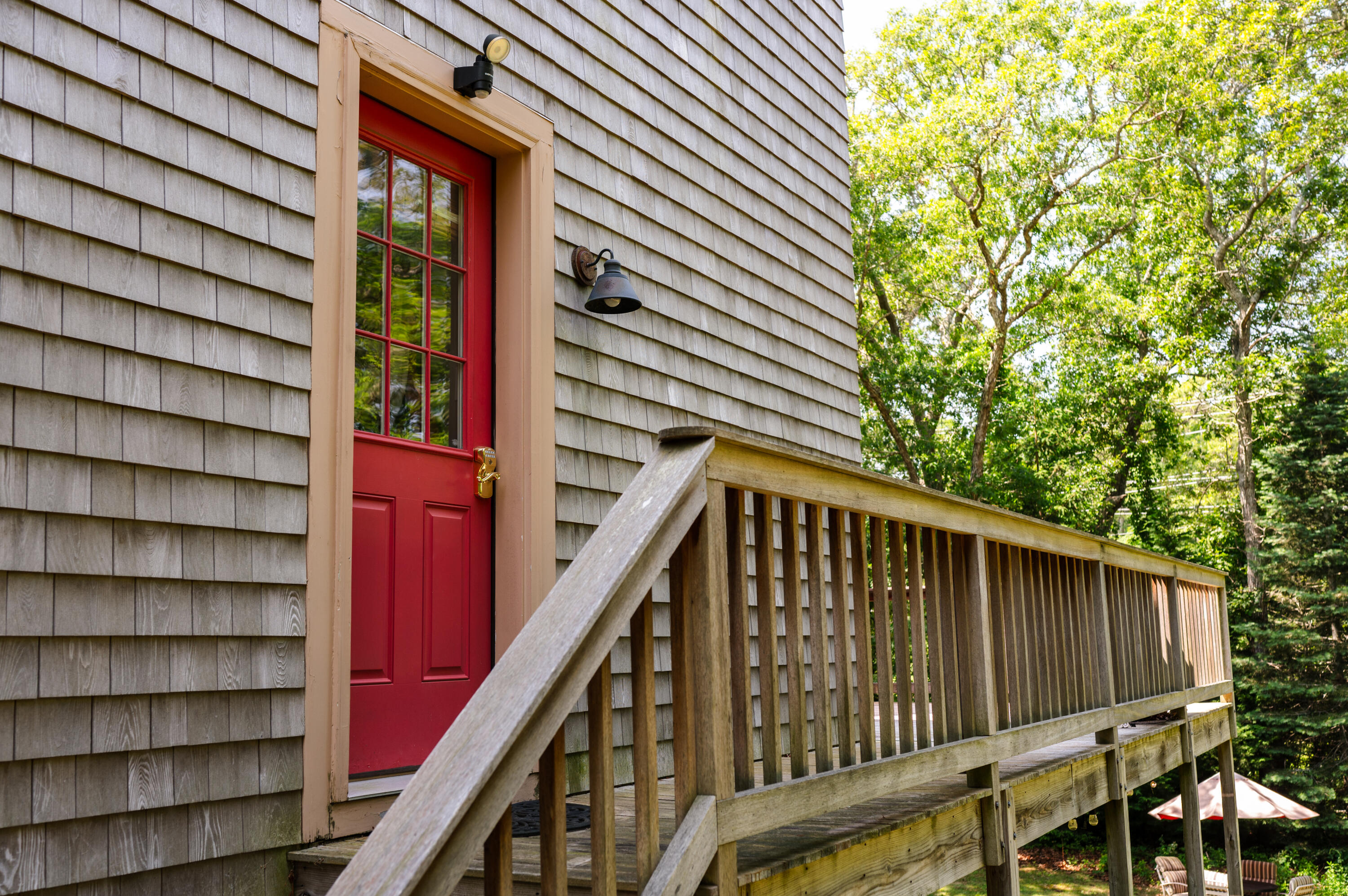 208 Irenes Way Tisbury, MA 02568 - Photo 3 of 70 a balcony with a book and wooden fence