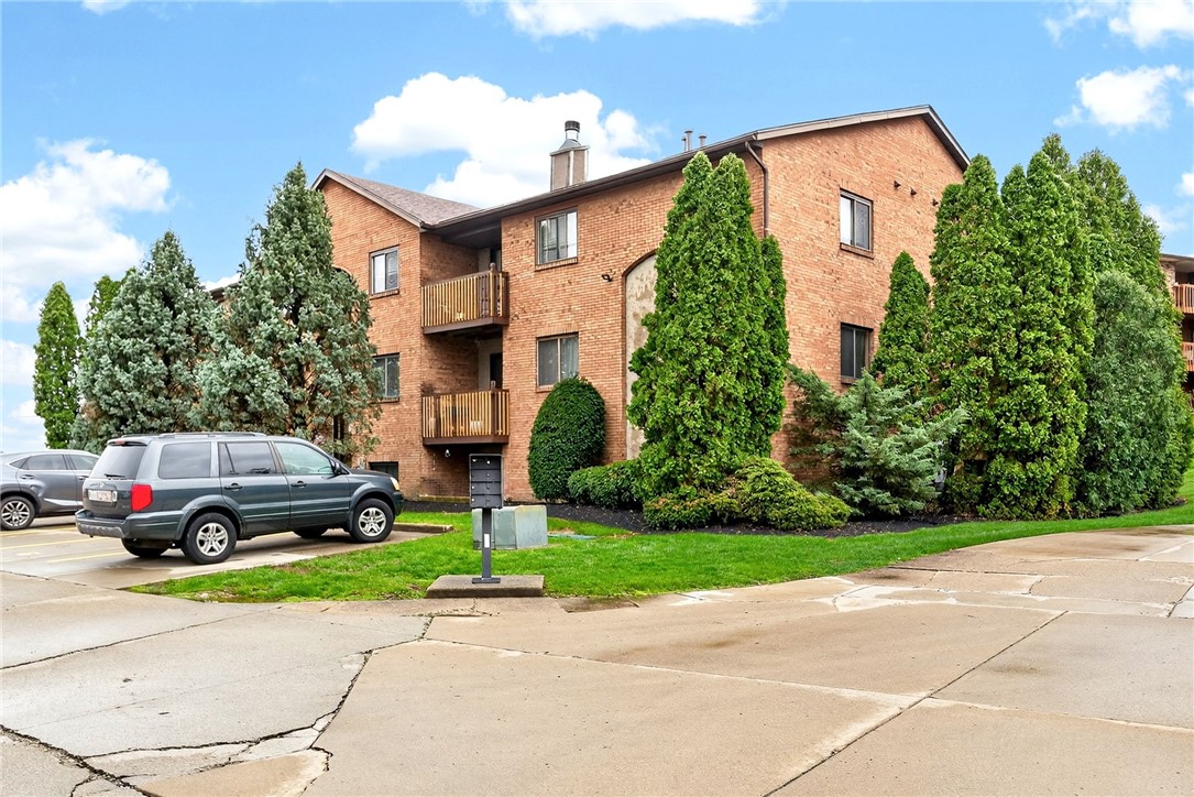 3151 Roesch Boulevard, Unit 6 Fairfield, OH 45014 - Photo 29 of 29 This brick building with wooden balconies offers charming residences amidst lush landscaping.