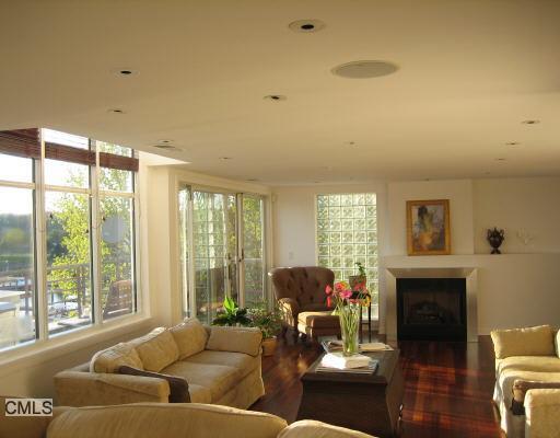 a living room with furniture large window and a fireplace