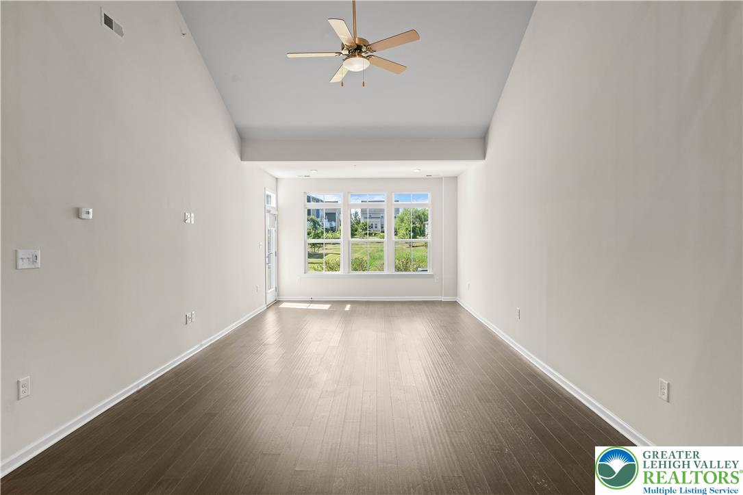 4758 Rafi Road Easton, PA 18045 - Photo 18 of 55 A spacious room offers rich hardwood flooring and a welcoming ceiling fan.