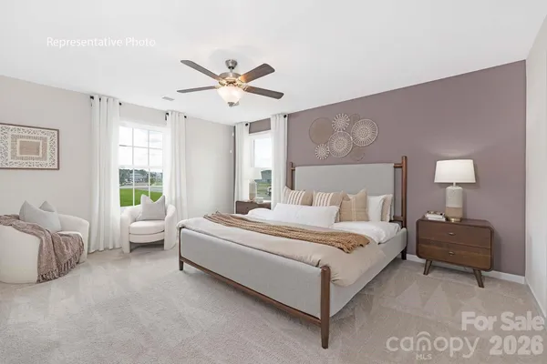 a bedroom with a bed couch and window