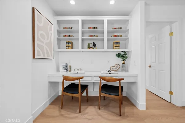 a view of a dining room with chairs and table in it