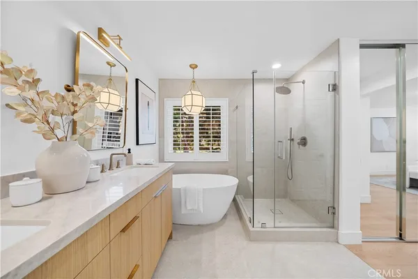 a spacious bathroom with double vanity and a shower
