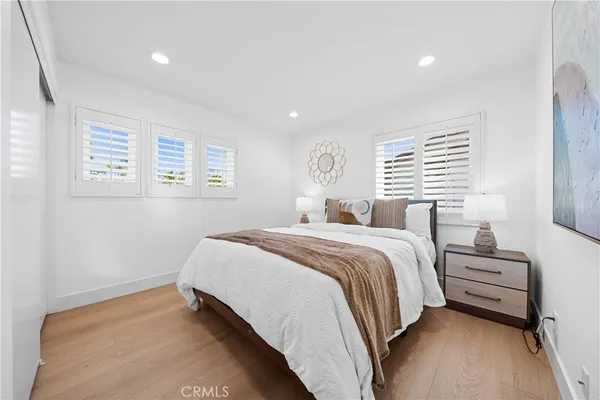 a bedroom with a bed and a large window