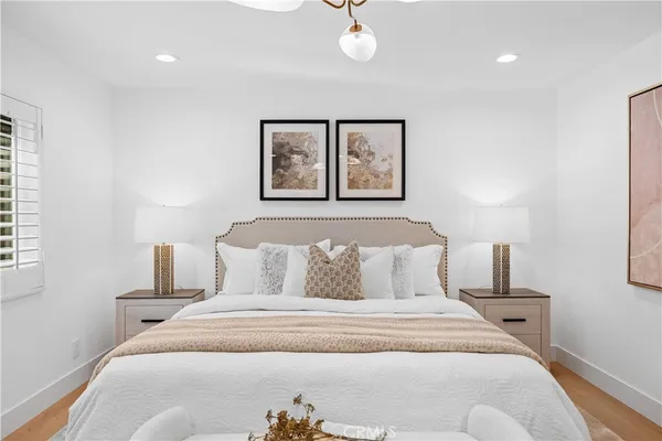 a bedroom with a bed and a lamp