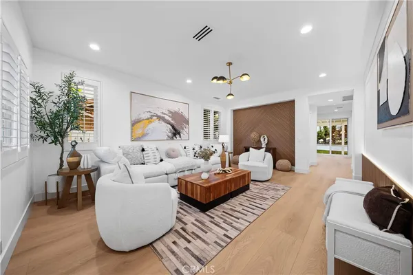 a living room with furniture and a potted plant