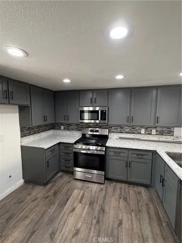 a kitchen with wooden floors and a sink