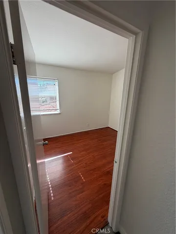 a view of room with window and wooden floor