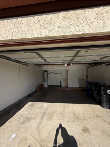 a front view of a house with a garden and trees