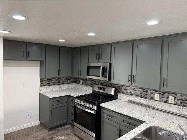 a kitchen with a sink stove and cabinets