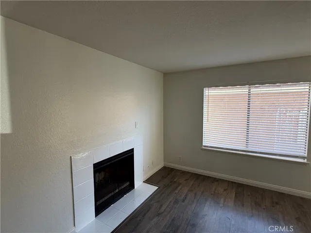 a room with a fireplace and wooden floor