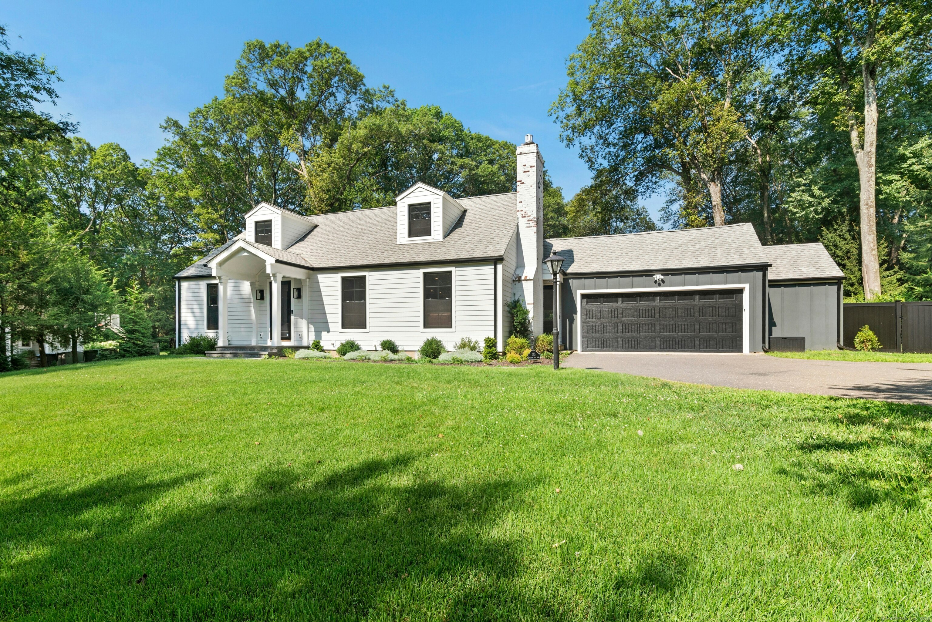 515 Belden Hill Road Wilton, CT 06897 - Photo 1 of 1 a front view of a house with a garden and porch