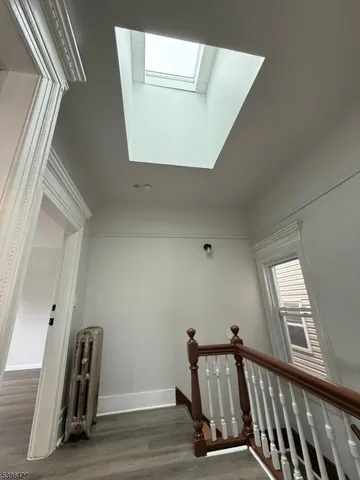 a view of a hallway with staircase and a window