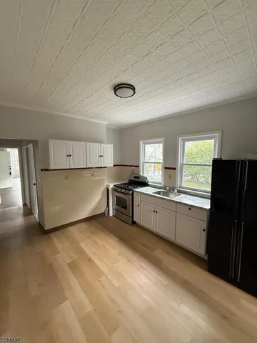 a large kitchen with cabinets and stainless steel appliances