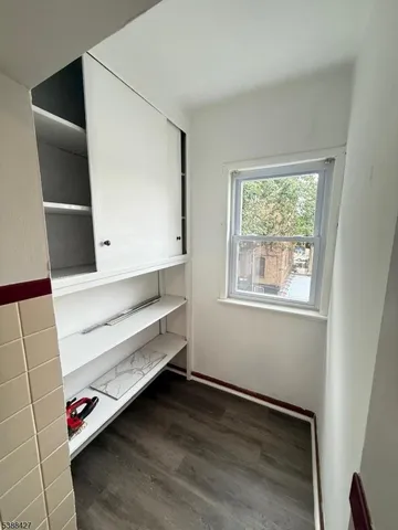 a view of room with window and wooden floor