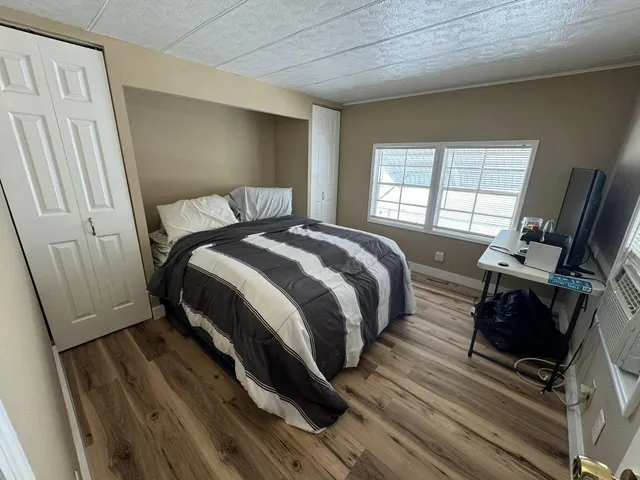 a bed sitting in a bedroom next to a window