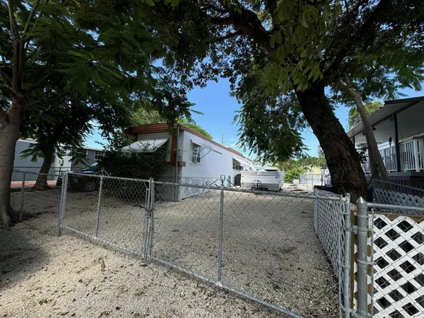 a backyard of a house with lots of trees