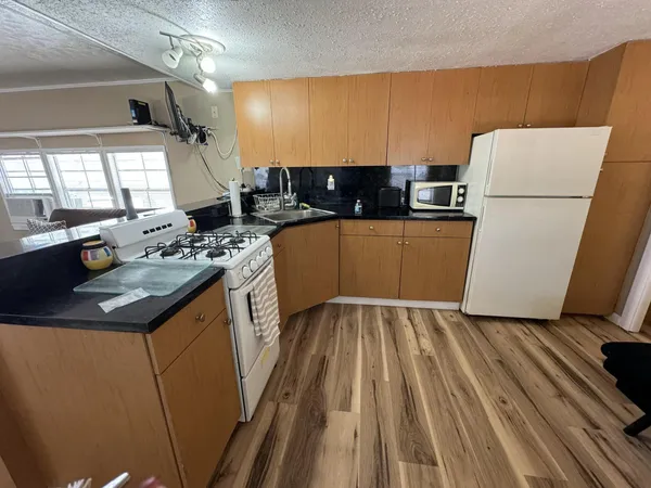 a kitchen with sink a refrigerator and a stove