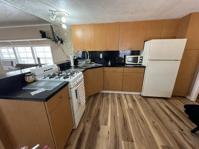 a kitchen with sink a refrigerator and a stove
