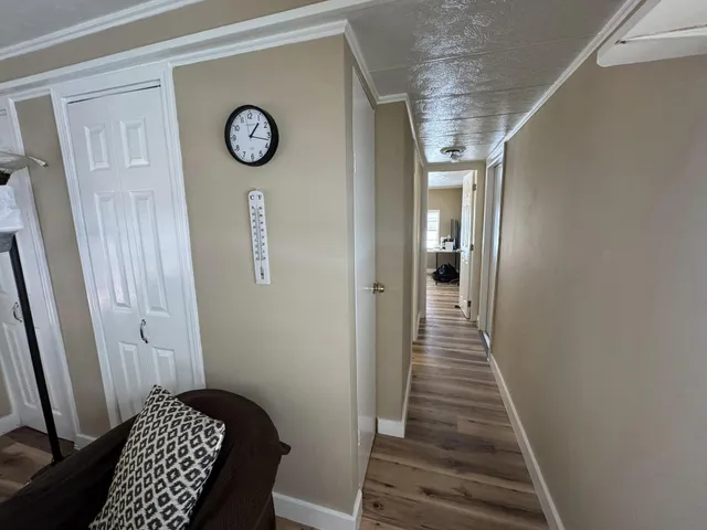 a view of hallway with wooden floor