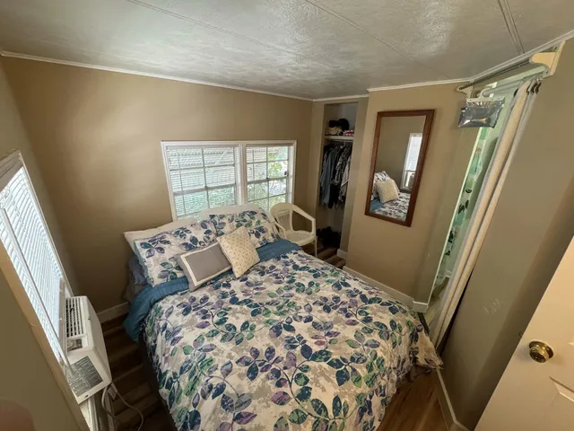 a bed sitting in a bedroom next to a window