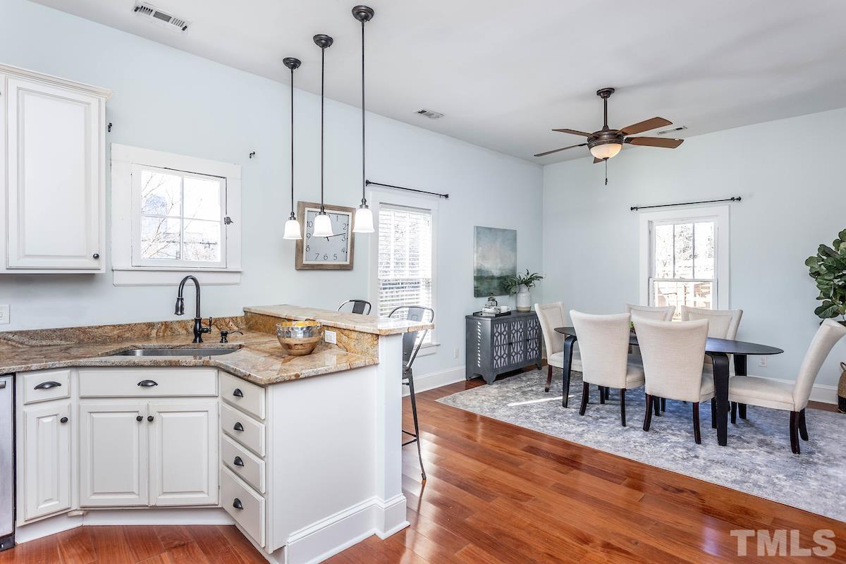 529 East Martin Street Raleigh, NC 27601 - Photo 12 of 29 a view of a kitchen counter space a sink and chairs