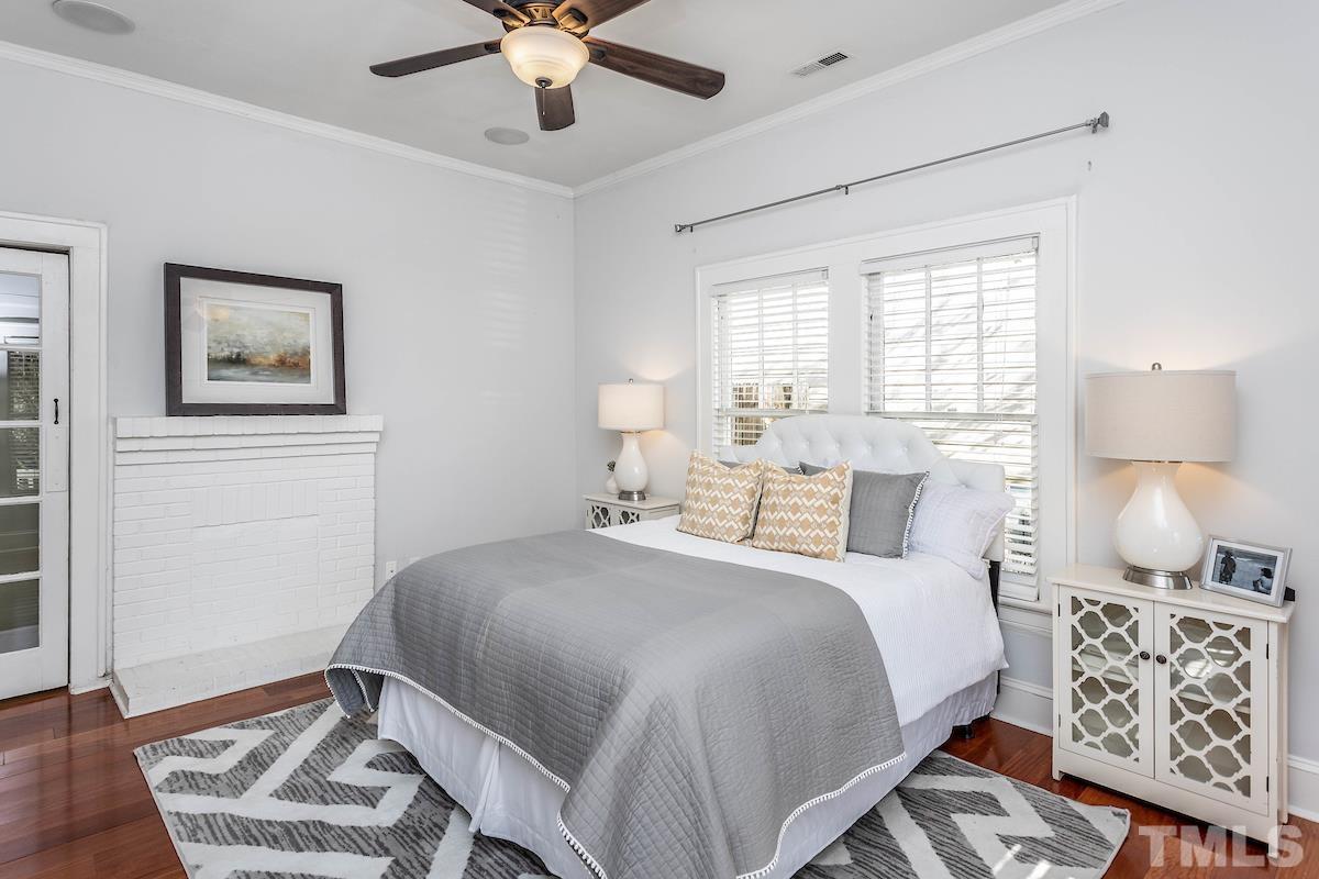 529 East Martin Street Raleigh, NC 27601 - Photo 21 of 29 a bedroom with a bed and a lamp on a dresser