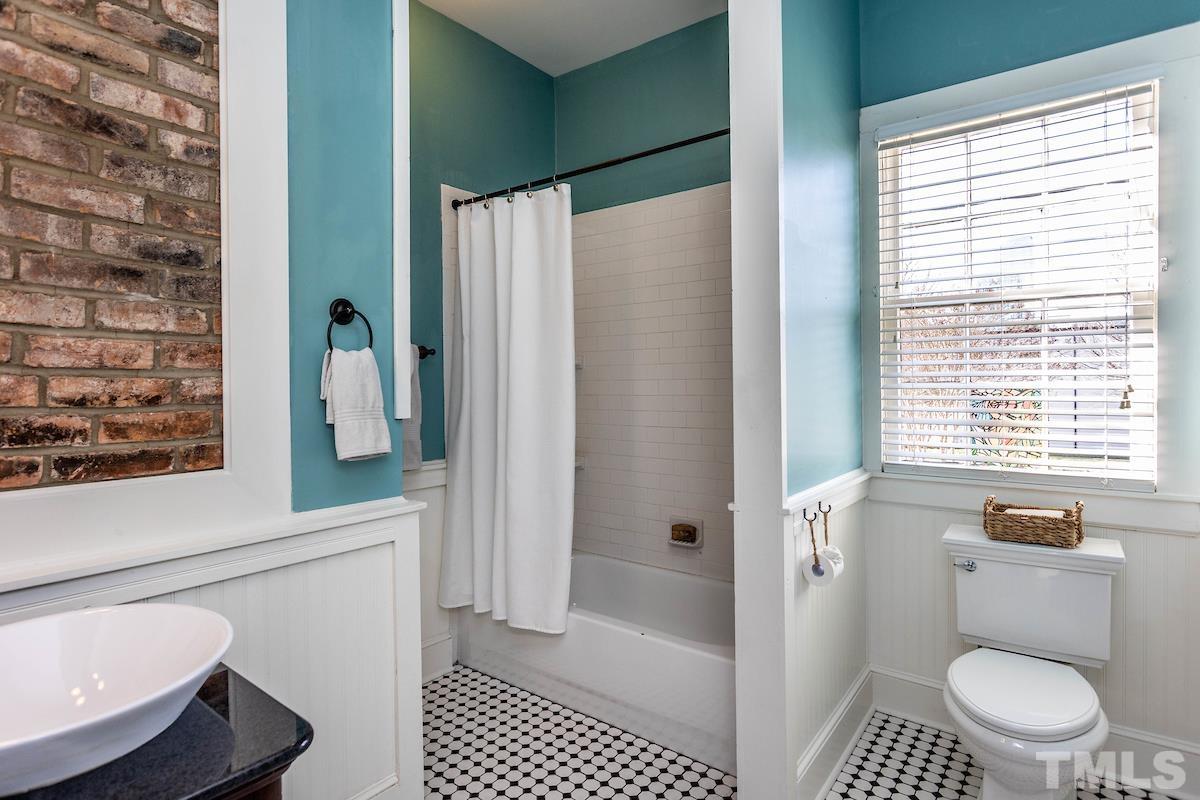 529 East Martin Street Raleigh, NC 27601 - Photo 24 of 29 a bathroom with a toilet a sink and a shower