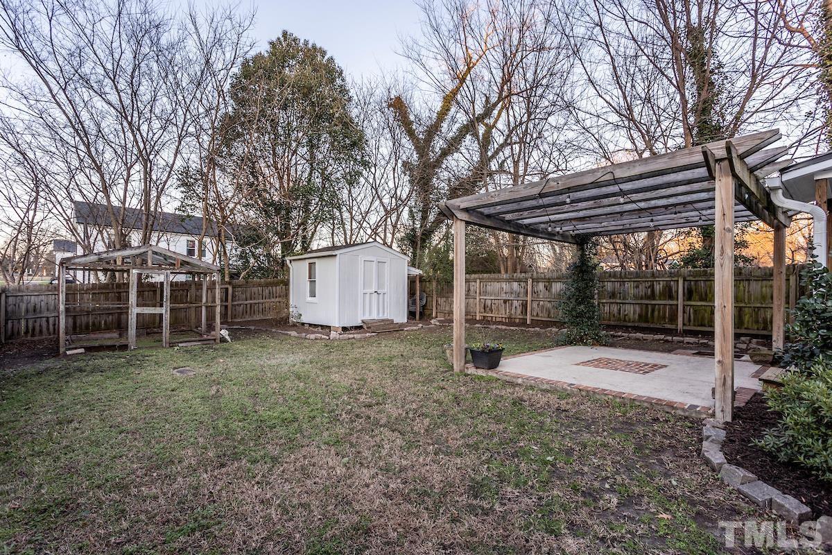 529 East Martin Street Raleigh, NC 27601 - Photo 26 of 29 a view of a backyard with large trees and a small yard