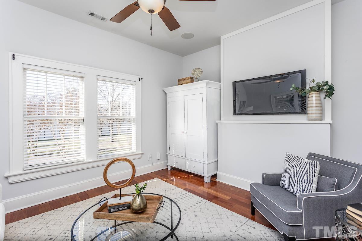 529 East Martin Street Raleigh, NC 27601 - Photo 6 of 29 a living room with furniture a flat screen tv and a window